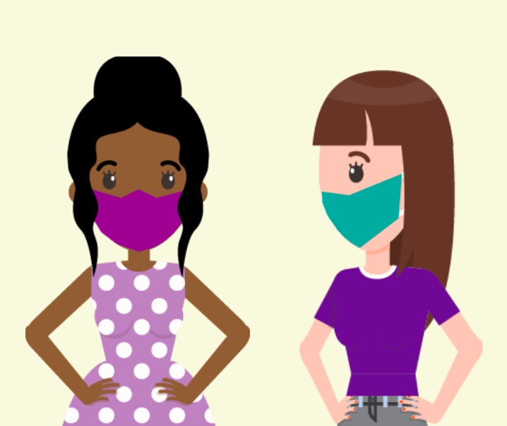 Two women standing next to each other wearing masks.